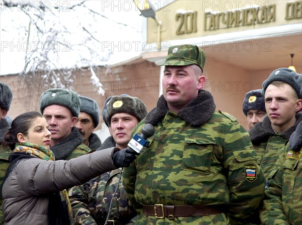 Oleg kozlov, a warrant officer of the 201st russian motorized division stationed in tajikistan pictured asking president vladimir putin a question during his live dialogue with russian people broadcast by tv, dec, 19, 2002.