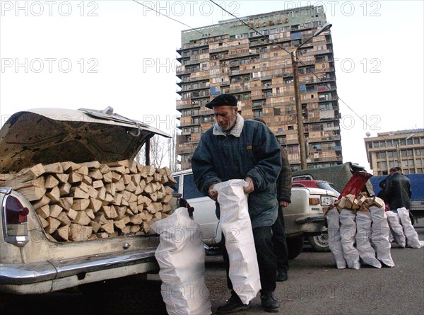 Tibilisi,georgia, january 15 2003: picture shows the selling of logs in downtown tiblisi near the iveria hotel , an unusually cold winter in georgia forced the residents of the city to seek means for heating of the premises as the central heating systems do not operate here , (photo itar-tass- 'eye of georgia' / david khizanishvili) .