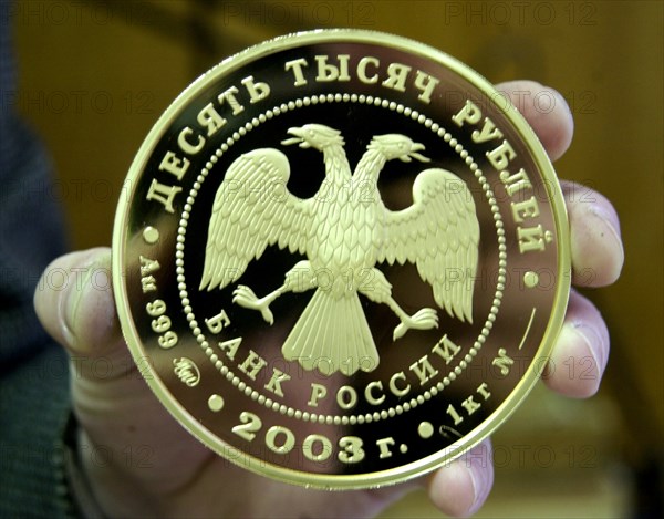 Moscow, russia, january 29 2003, picture shows a memorial gold coin,dedicated to the 300th anniversary of st,petersburg, made at the moscow mint , this enterprise equipped with modern machinery manufactures different coins, including memorial ones, state medals and orders, different badges ,jewels and some souvenir articles, alexander yakovlev   .
