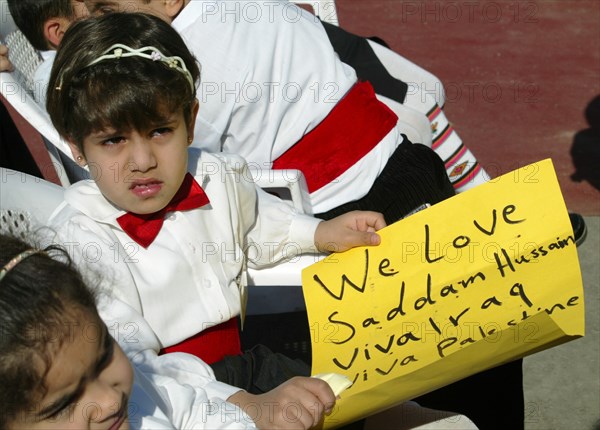 Bagdad, iraq, february 17 2003, young residents of bagdad pictured with a poster in hands saying about their love of saddam hussein in a street in downtown the city, (photo itar-tass/vitaly belousov).