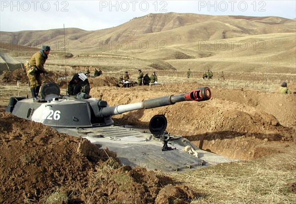 Tajikistan, february 18, 2002, servicemen of the russian 201st division pictured during the military exercises held on the 'lyaur' training range in the south of tajikistan, units of a separate batallion of the collective fast reaction force of the cis also took part in field firing manoeuvre, the troops drilled cooperation and tactics in case of penetration of large groups of terrorists to the republic's territory.