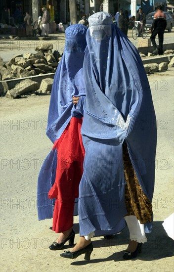 Afghanistan, march, 7 2003, afghani women wearing burkas, traditional capes with veils hiding the person, try to look attractively: from under the cape clothes corresponding to a local fashion and footwear are always visible, a photo sergey zhukova   .