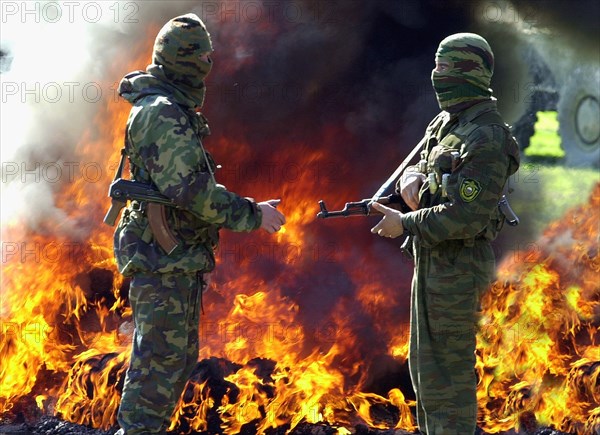 Tajikistan, march 12 2003, russian border guards serving on the tajik-afghan frontier pictured burning drugs confiscated from the traffickers , (photo itar-tass/ sergei zhukov).