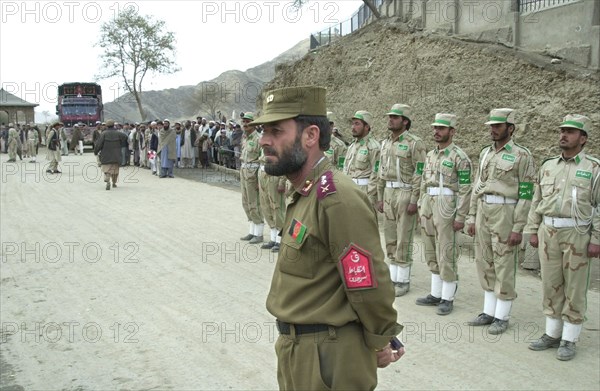 Afghanistan, march 17 2003, lieutenant-colonel dagarman khazratgul (in pic) and his subordinates keep the order at tourkham border crossing point, thousands of people cross daily the border between afghanistan and pakistan through this point, there are many families that are still separated as the result of flood of refugees from afghanistan.