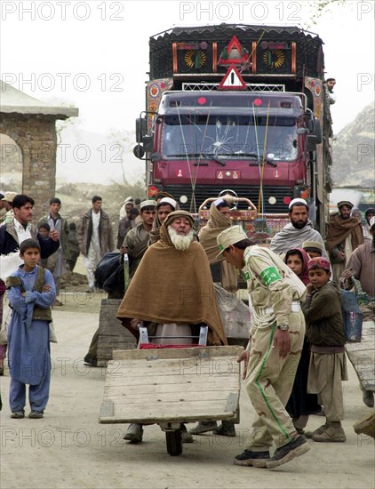 Afghanistan, march 17 2003, thousands of people cross daily the border between afghanistan and pakistan through tourkham border crossing point, there are many families that are still separated as the result of flood of refugees from afghanistan.