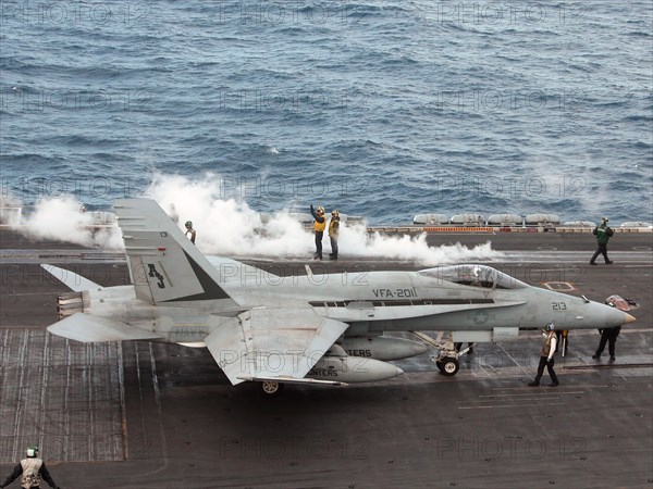 Mediterranean, march 21, 2003, fa-18 hornet (in pic) being prepared for a take-off, the planes based on the aircraft carrier make sorties within the framework of iraqi operation.