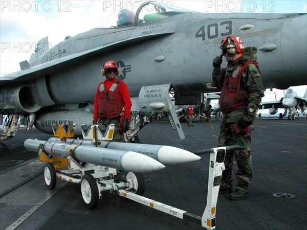 Caption: tas15: mediterranean sea, uss theodore roosevelt, march 22, 2003, servicemen removing unused aim-120 air-to-air missiles from a fa18 hornet fighter after the aircraft returned on board of the theodore roosevelt carrier from the first raid on iraq, (photo itar-tass / konstantin yelovsky) .