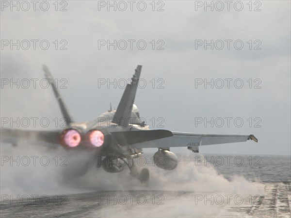 Uss 'theodore roosevelt' aircraft carrier, mediterranean sea, march 26 2003, a hornet fa-18 fighter pictured taking off from the flying-on deck of the uss 'theodore roosevelt' aircraft carrier for an execution of a combat mission.