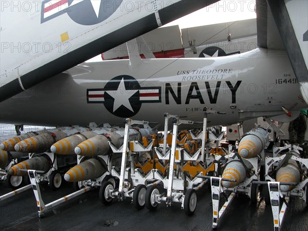 Uss 'theodore roosevelt ' aircraft carrier, mediterranean sea, march 26 2003, the jdam bombs pictured against the background of a e-2-c radio-electronic warfare plane on the deck of the uss 'theodore roosevelt ' aircraft carrier.