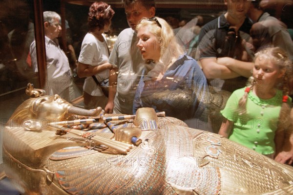 Caption: egypt, the russian tourists at a gold sarcophagus of pharaoh tutanhamona (in picture), despite military actions in iraq, the quantity of the russian tourists leaving on rest to egypt, was not reduced, (april 2003) photo vitaly ivanov (itar-tass) .