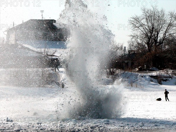 Caption: tas31: kurgan, russia, april 3, 2003, ice being blown near the water power development on the tobol river in kurgan to prevent spring floods and possible damage of water power facilities, (photo itar-tass/alexander alpatkin) .
