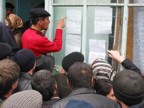 Makhachkala, russia, april 10, 2003, relatives pictured scrutinizing the list of victim of the tragedy happened in a boarding school for deaf and dumb children which was ablazed on thursday having killed 28 people over a hundred children were taken to the hospitals.