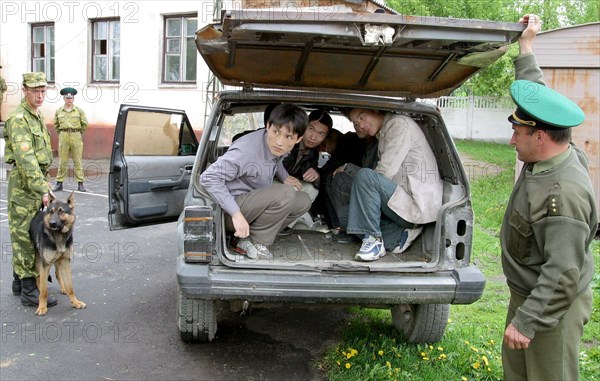 Caption: tas 27, belarus, may 12, 2003, a group of illegal immigrants from china (in picture) was detained by belarus border guards not far from the belarussian-ukrainian frontier , (photo itar-tass/ viktor tolochko) .