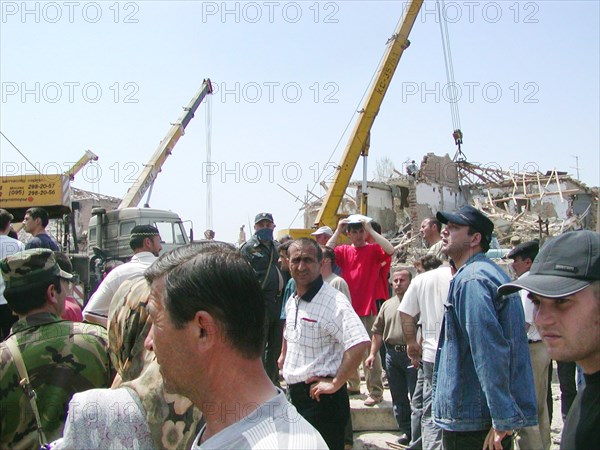 Caption: tas22, chechnya, russia, may 13, 2003, people pictured clearing the debris in the village of znamenskoye where a powerful explosion ruined the buildings that housed the district administration ,on monday , many people were killed and injured in the terrorist act, (photo itar-tass/ veniamin bekker) .