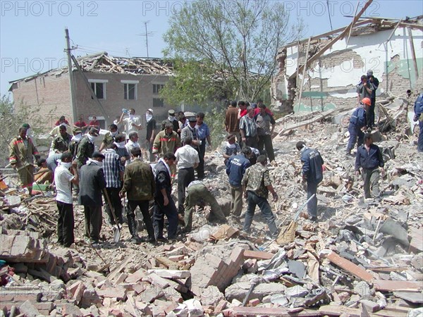 Chechnya, russia, may 12, 2003, people pictured clearing the debris in the village of znamenskoye where a powerful explosion ruined the buildings that housed the district administration ,on monday, many people were killed and injured in the terrorist act.