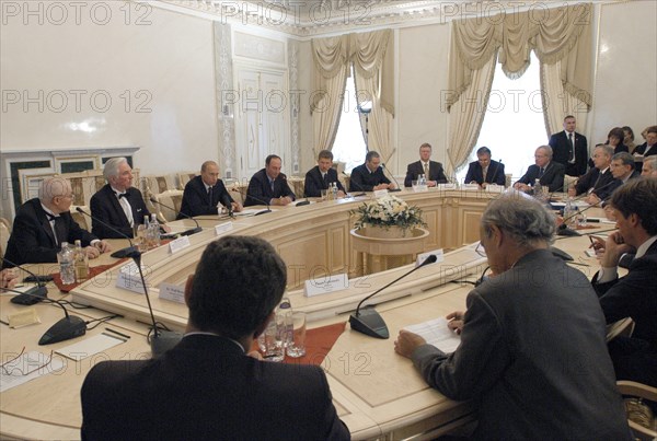 Russian president vladimir putin (centre in the background) seen presiding at a conference of laureates of the global energy international prize and top managers of russian energy corporations, gazprom, the unified energy systems of russia and yukos with the support of which the award was established in the end of2002 by the initiative of nobel prize winner zhores alfyorov, constantin palace, strelna, petersburg region, russia, june 15, 2003.