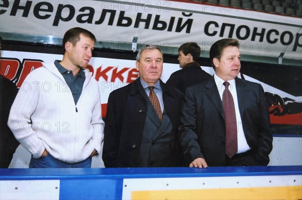Left to right: governor of chukotka roman abramovich; governor of the omsk region leonid polezhayev, and anatoly bardin, president of the local 'avangard' ice hockey club watch the 'avangard' players in action, omsk, russia, october 3, 2003.
