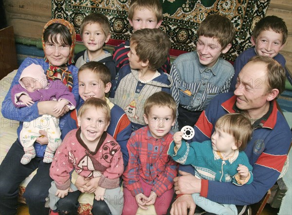 Chuvashia, siberia, russia, october 25 2003, chuvash family living in poverty, mother valentina pours soup for father leonid and their children, there are ten boys in the family, the elder is 13 years old and the youngest is only three weeks old.