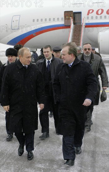 President of russia vladimir putin (l) in borispol airport, he arrived for a two-day working visit and was welcomed by chief of the president's administration of ukraine, viktor medvedchuk, kiev, ukraine, january 23 2004.