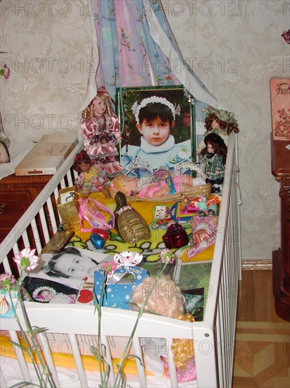 The portrait, bed and toys of a 4-year-old diana - the daughter of a construction engineer vitaly kaloyev, who is suspected of the murder of an air traffic controller peter nielsen, north ossetia, russia, february 27 2004.