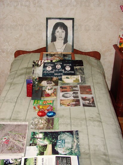 The portrait, bed and photographs of svetlana - the wife of a construction engineer vitaly kaloyev, who is suspected of the murder of a swiss air traffic controller peter nielsen, north ossetia, russia, february 27 2004.
