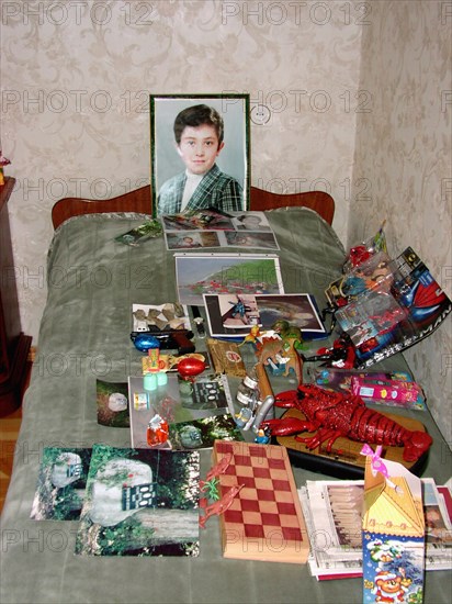 The portrait, bed and toys of a 10-year-old kostya - the son of a construction engineer vitaly kaloyev, who is suspected of the murder of a swiss air traffic controller peter nielsen, north ossetia, russia, february 27 2004.
