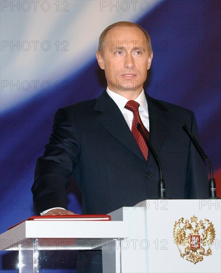 President vladimir putin taking the oath of office during his inauguration ceremony in st,andrew's hall in the kremlin on friday, may 7, 2004.