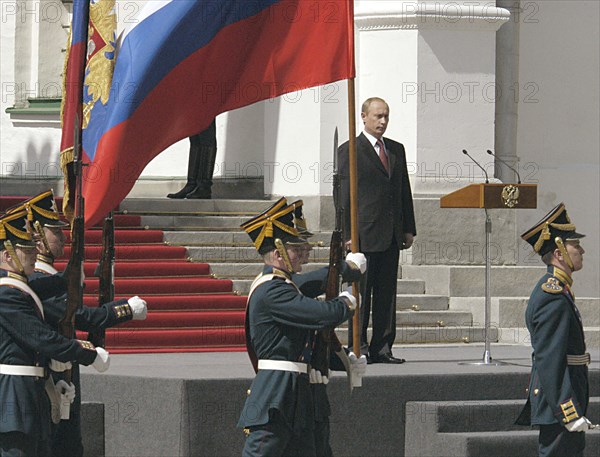 President vladimir putin viewing a parade of kremlin regiment held in honour of his inauguration on the cathedral square in the kremlin on friday, may 7, 2004.