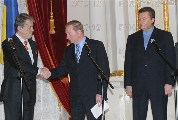 Ukraine election crisis 2004, ukrainian outgoing president leonid kuchma (c) addresses opposition leader west-leaning viktor yushchenko (l) as prime minister viktor yanukovich looks on following round-table talks in kiev, ukraine, november 28 2004.