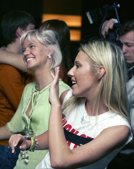 Pop singer natasha ionova aka glyukoza (l) and kseniya sobchak, the wealthy daughter of anatoly sobchak, a leading democratic reformer in the late-1980s, smile during the durak card game tournament at moscow's yevropa (europe) casino, 4/05 moscow, russia.