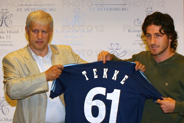 St, petersburg, russia, august 2, 2006, fc zenit president sergei fursenko, left, and turkish national team forward fatih tekke hold a soccer shirt bearing the number 61 and tekke's name as they pose for a photograph at the kempinski hotel during the introduction of tekke as new player at zenit.