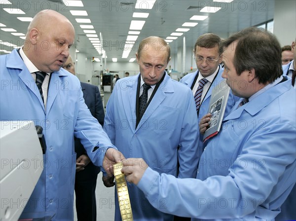President of joint stock financial corporation sistema alexander goncharuk, left, russian president vladimir putin, center, and 'nllme and mikron' company general director gennady krasnikov, right, take a tour of the mikron factory in zelenograd, 24 miles north-west of moscow, october 17, 2006.