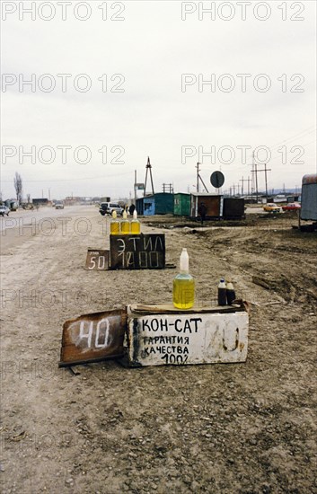Second chechen war, illegally produced petrol, made at ubiquitous mini plants, being sold roadside in grozny, chechnya, july 2000.