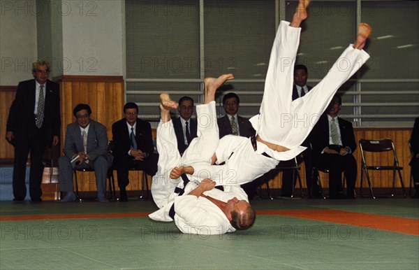 Russian president vladimir putin throwing an opponent at a judo demonstration during his state visit to japan in september 2000, tokyo.