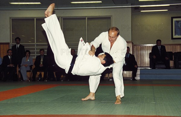 Russian president vladimir putin throwing an opponent at a judo demonstration during his state visit to japan in september 2000, tokyo.