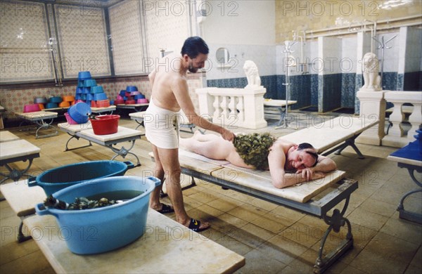 A man being hit with birch leaves at the famous sandunov bath house, built in 1896 and recently restored, moscow, russia, 2001.