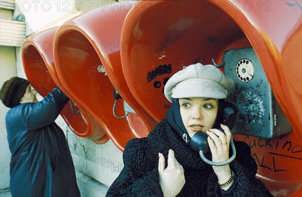 Fashionable young woman at the public phones in lipetsk which have been free since 1996, april 2001.