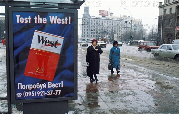 An advertisement for 'west' brand cigarettes on a bus shelter on tverskaya street in moscow, russia.