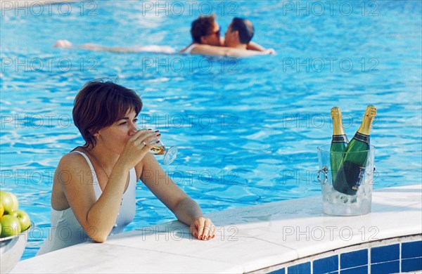 A guest at the hotel lazurny enjoying a poolside drink, sochi, krasnodar region, russia.