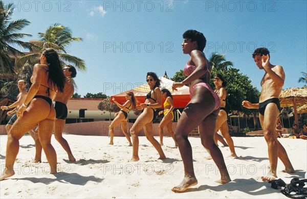 A dance class being held on the beach at a resort on varadero beach, cuba.