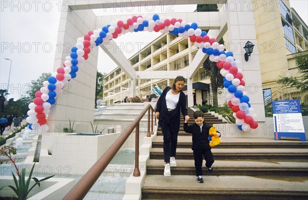 A mother and her son leaving the hotel kavkaz in sochi, krasnodar region, russia.