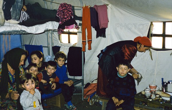A chechen family in a tent at the 'sputnik' refugee settlement in ingushetia, november 1999.