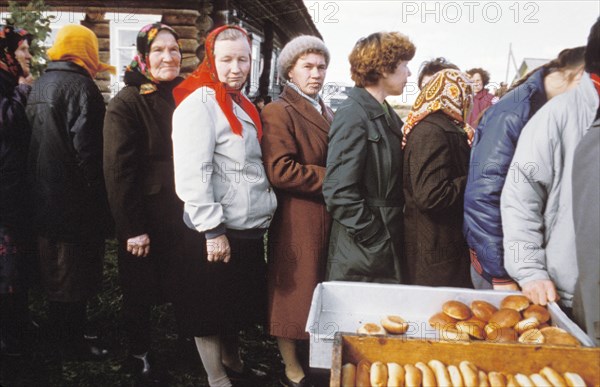 Residents of a village of berezkino in the kirov region of the ussr line up to buy rolls on may day eve during the times of economic reforms, 1990.