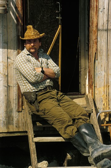 A member of a team of geologists who are prospecting for gold along the kozhim river in the komi region of russia, 1990s.