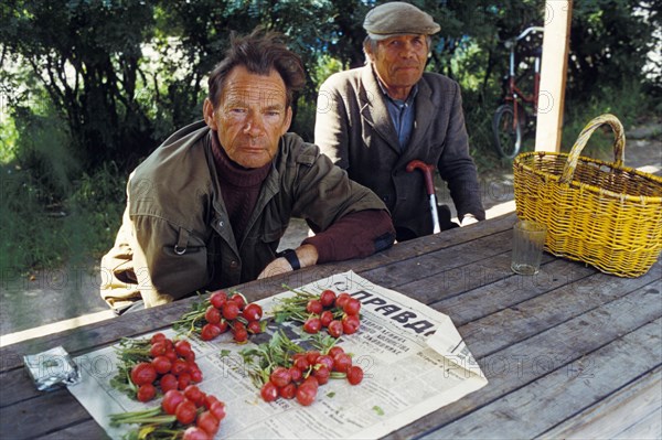 Street sellers with not much to offer at the market in the priozersk dist, of st, petersburg, russia, 1991.