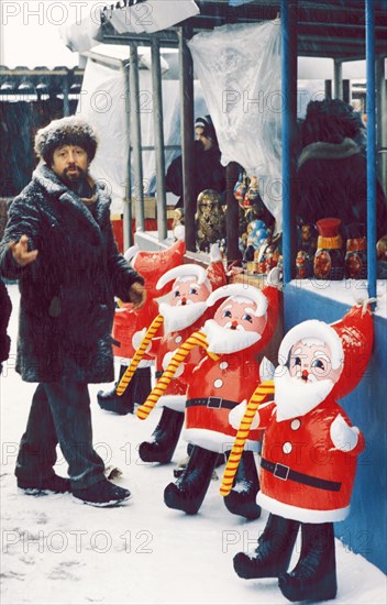 A man selling toys and souvenirs at the outdoor market (vernissazh) in izmailovo park, moscow, russia, 1990s.