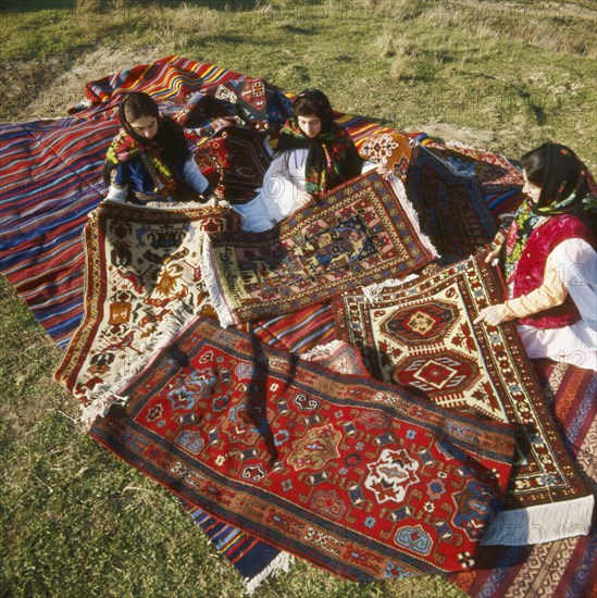 Carpet weavers of daghestan displaying their handicraft, russia.