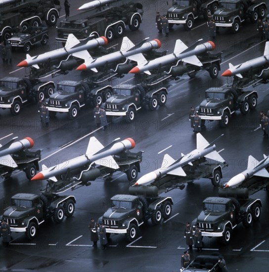 Trucks bearing sa-1 and sa-2 surface -to-air missiles lining up for a military parade in red square celebrating the 65th anniversary of the great october socialist revolution, november 7, 1982, moscow, ussr.