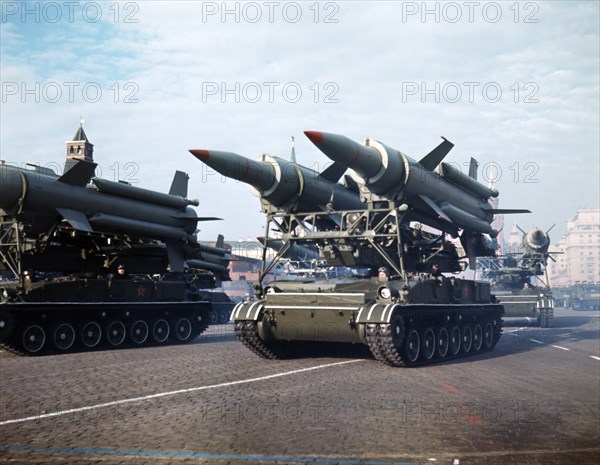 Motorized missile launchers with lyulev 2k11 'krug' (nato designation: sa-4 ganef) surface-to-air missiles at a military parade on november 7, 1980s, moscow, ussr.