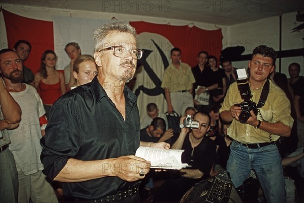 Eduard limonov, leader of the national bolshevik party, reading at the 'children's book of the dead' literary soiree which was held along with the poet alina vitukhnovskaya at the party's premises in frunzenskaya embankment on august 6, 2003, moscow, russia.
